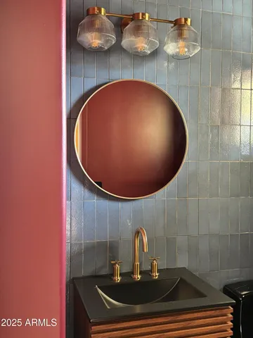 a white bed sitting in a bedroom next to a lamp