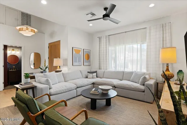 a kitchen with stainless steel appliances granite countertop a table chairs sink and white cabinets