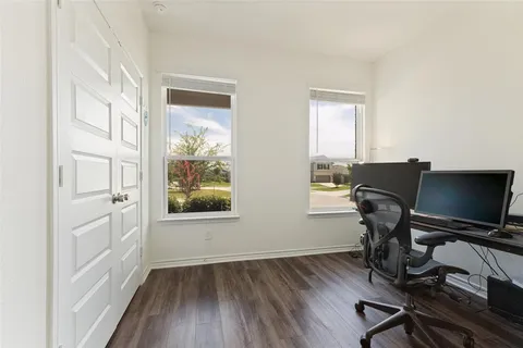 a view of workspace with wooden floor windows