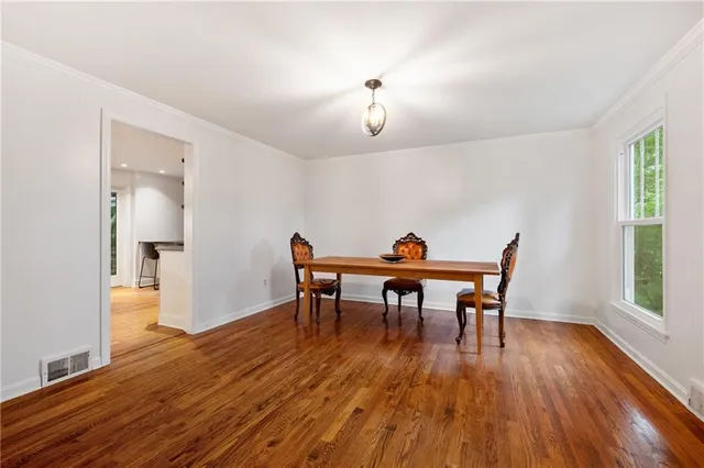 a view of a dining room with furniture and wooden floor