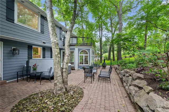 a view of a house with backyard sitting area and garden