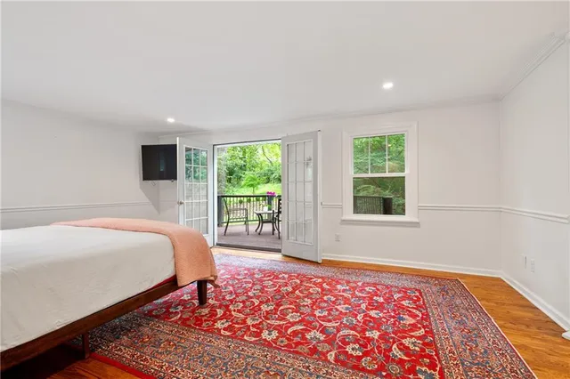 a bed sitting in a bedroom next to a window