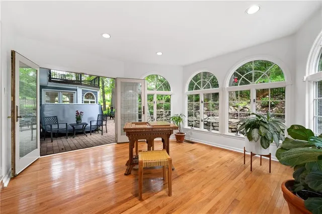 a living room with furniture and a large window with wooden floor