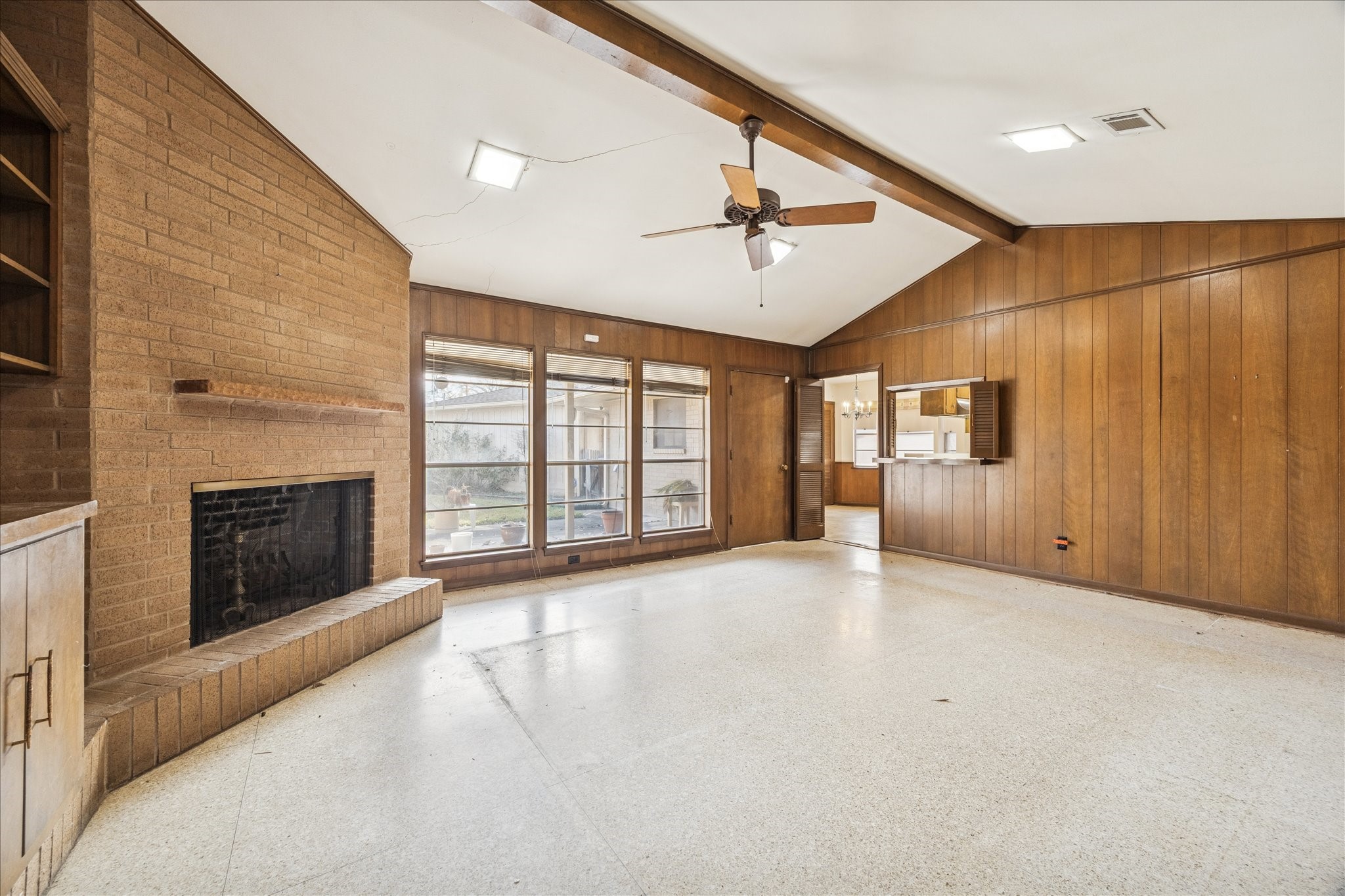 5751 Jason Street Houston, TX 77096 - Photo 2 of 19 Cathedral ceilings and paneling with many builtins and windows to bring in the natural light