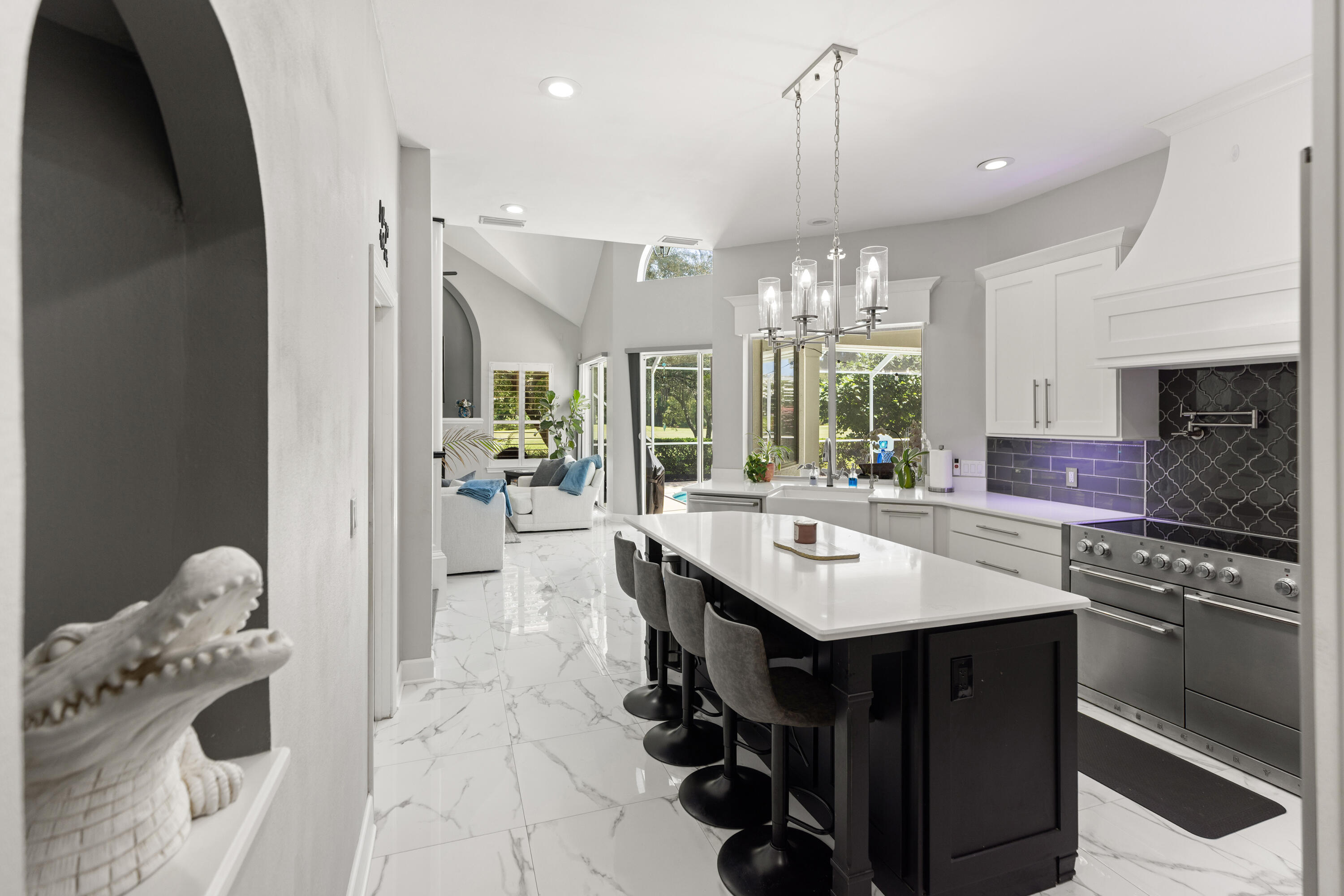 96 Garnet Place Destin, FL 32541 - Photo 14 of 90 a kitchen with kitchen island granite countertop a stove a chimney a sink and a dining table with wooden floor
