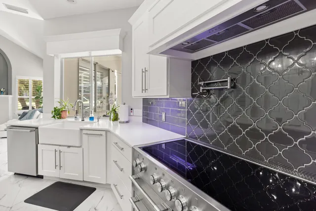 a bedroom with a bed a fireplace and a flat tv screen