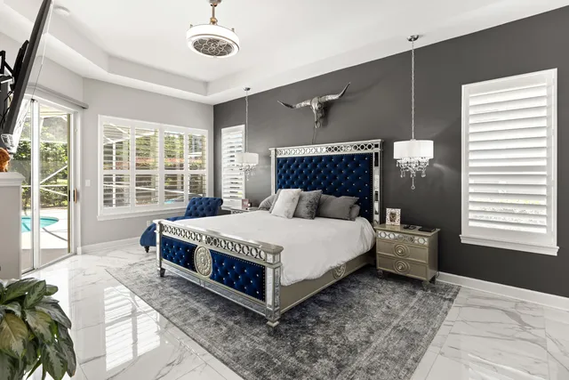 a bedroom with a large bed and a chandelier