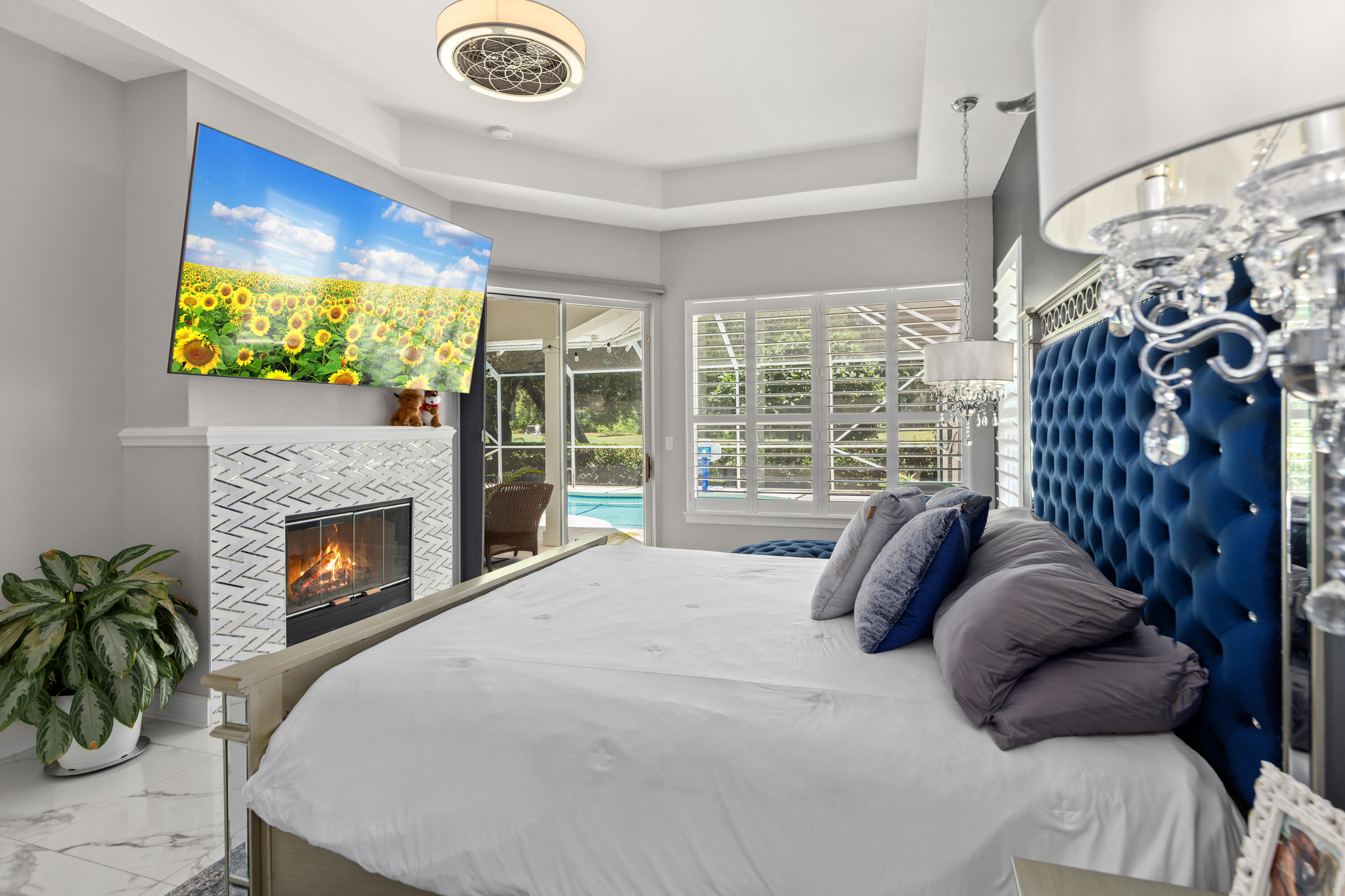 96 Garnet Place Destin, FL 32541 - Photo 29 of 90 a bedroom with a bed a fireplace and a flat tv screen