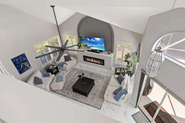 a view of a building with sitting area and furniture