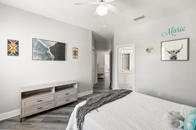 a view of a tennis ground with large trees