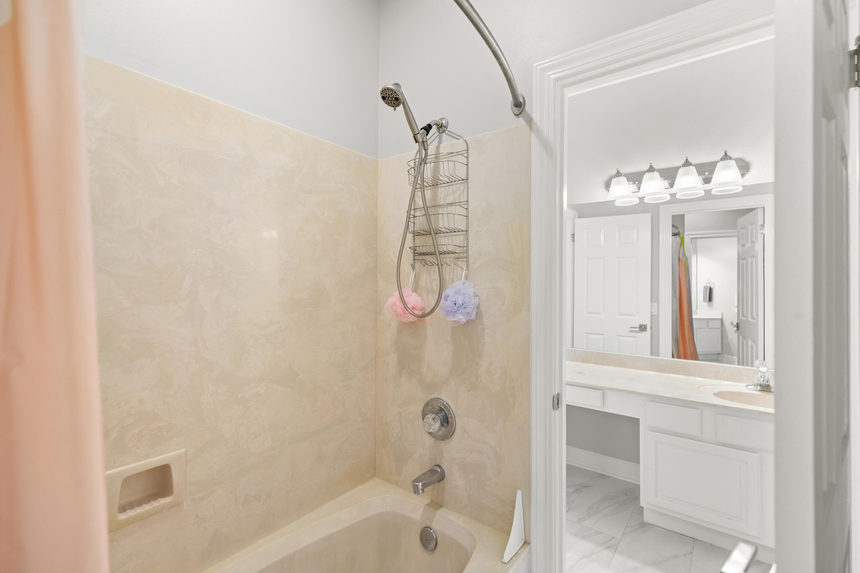96 Garnet Place Destin, FL 32541 - Photo 54 of 90 a bathroom with a shower a mirror and a bathtub