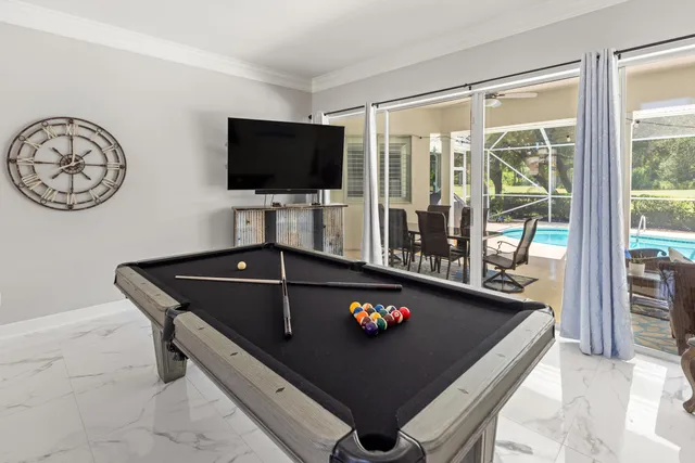 a view of a dining room with furniture a chandelier and wooden floor