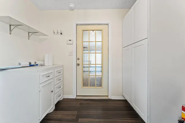 a view of a hallway with closet and wooden floor