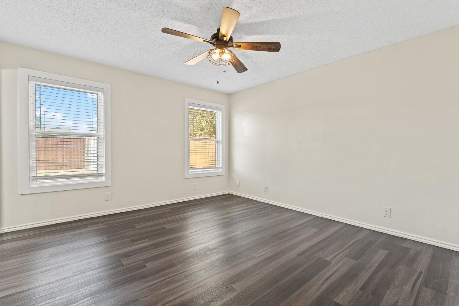 6154 38th Street Lubbock, TX 79407 - Photo 13 of 23 a view of an empty room with window and wooden floor