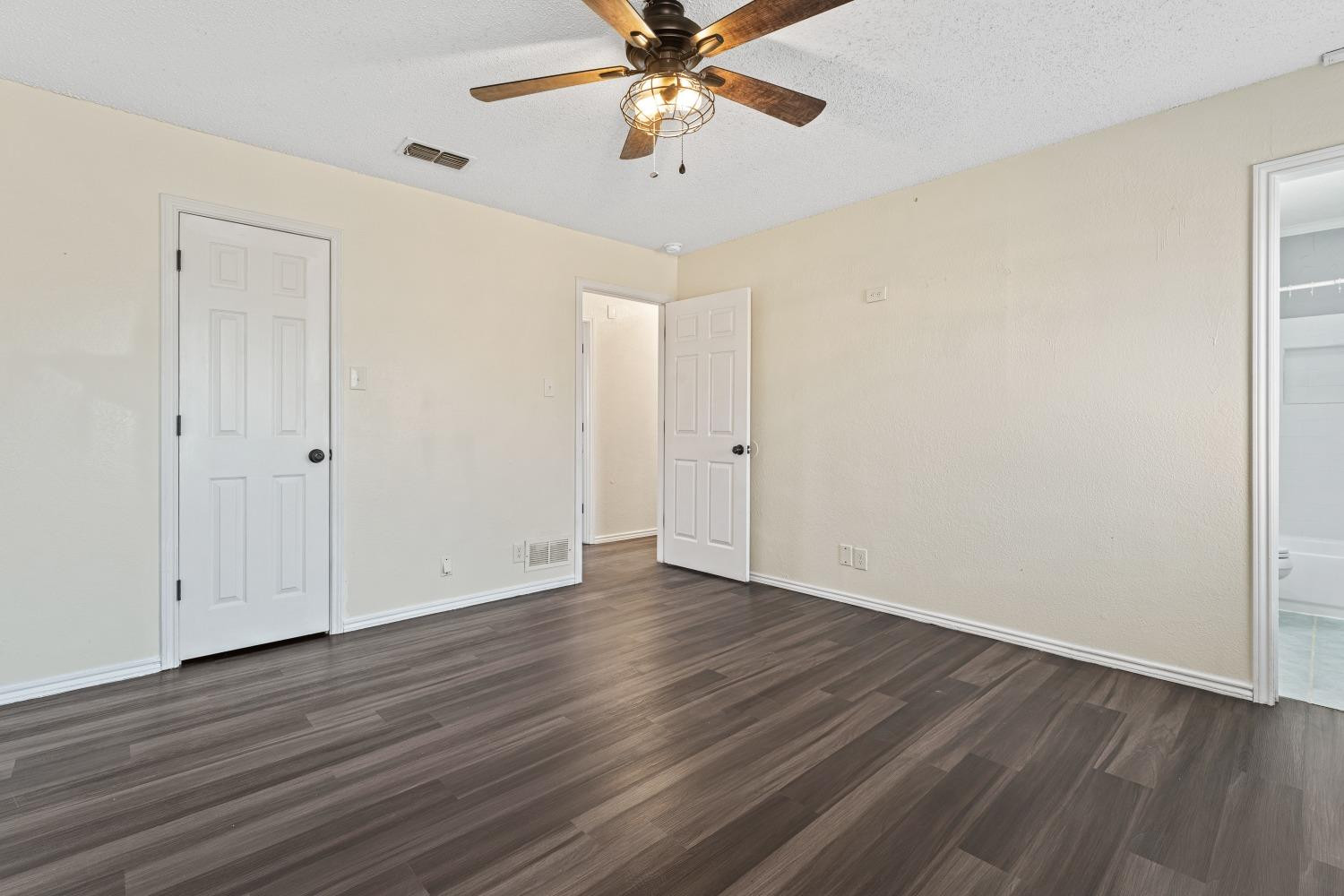6154 38th Street Lubbock, TX 79407 - Photo 14 of 23 a view of an empty room with window and wooden floor