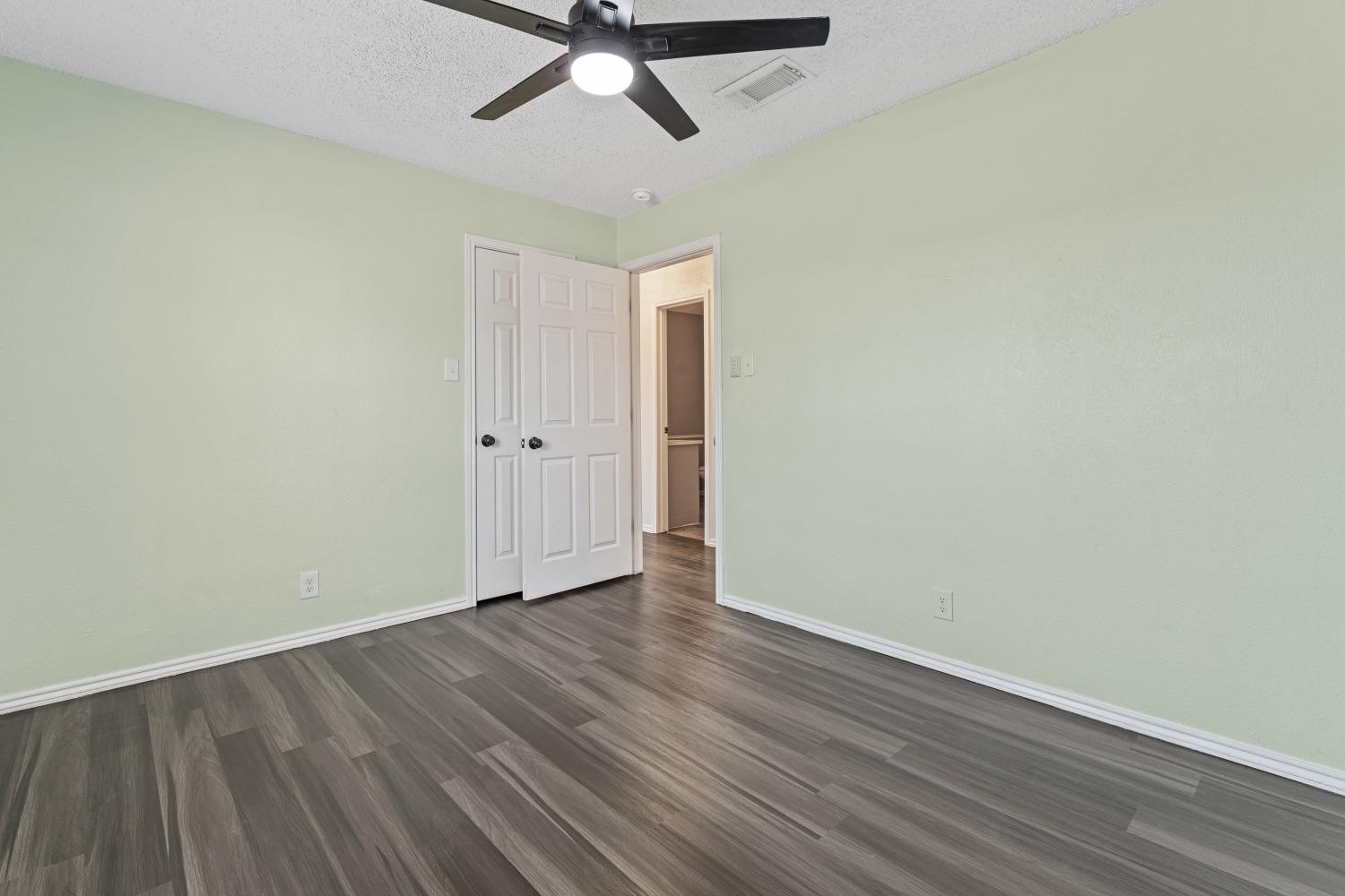 6154 38th Street Lubbock, TX 79407 - Photo 17 of 23 an empty room with wooden floor and windows