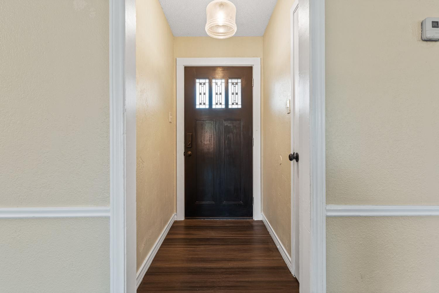 6154 38th Street Lubbock, TX 79407 - Photo 4 of 23 a view of a hallway with wooden floor and a front door