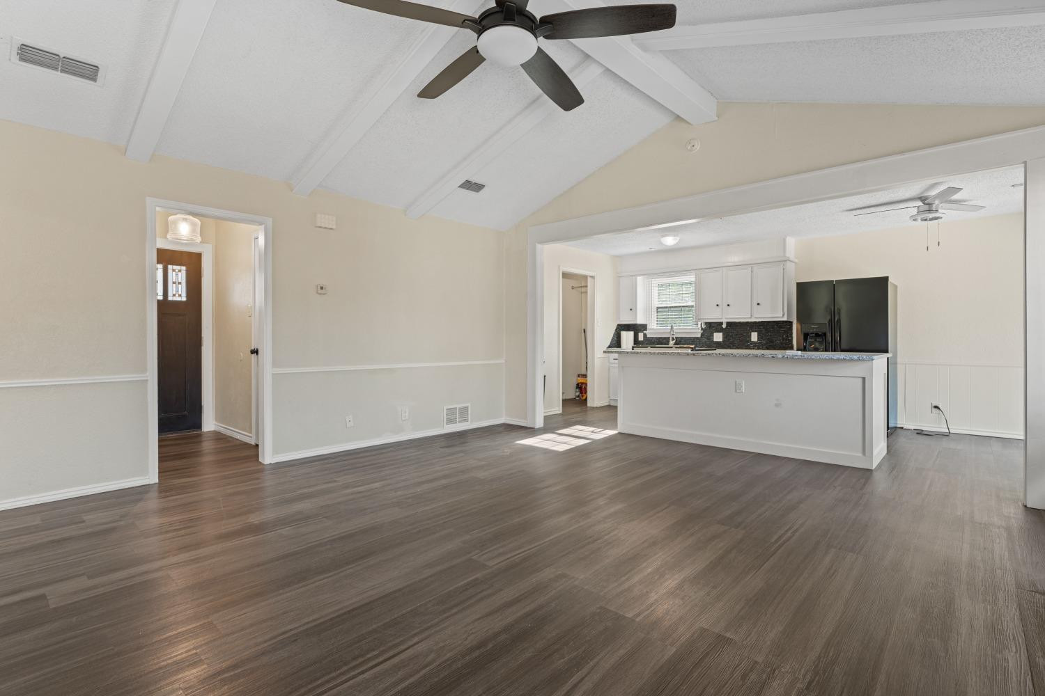 6154 38th Street Lubbock, TX 79407 - Photo 6 of 23 a view of a kitchen with a sink cabinets and wooden floor