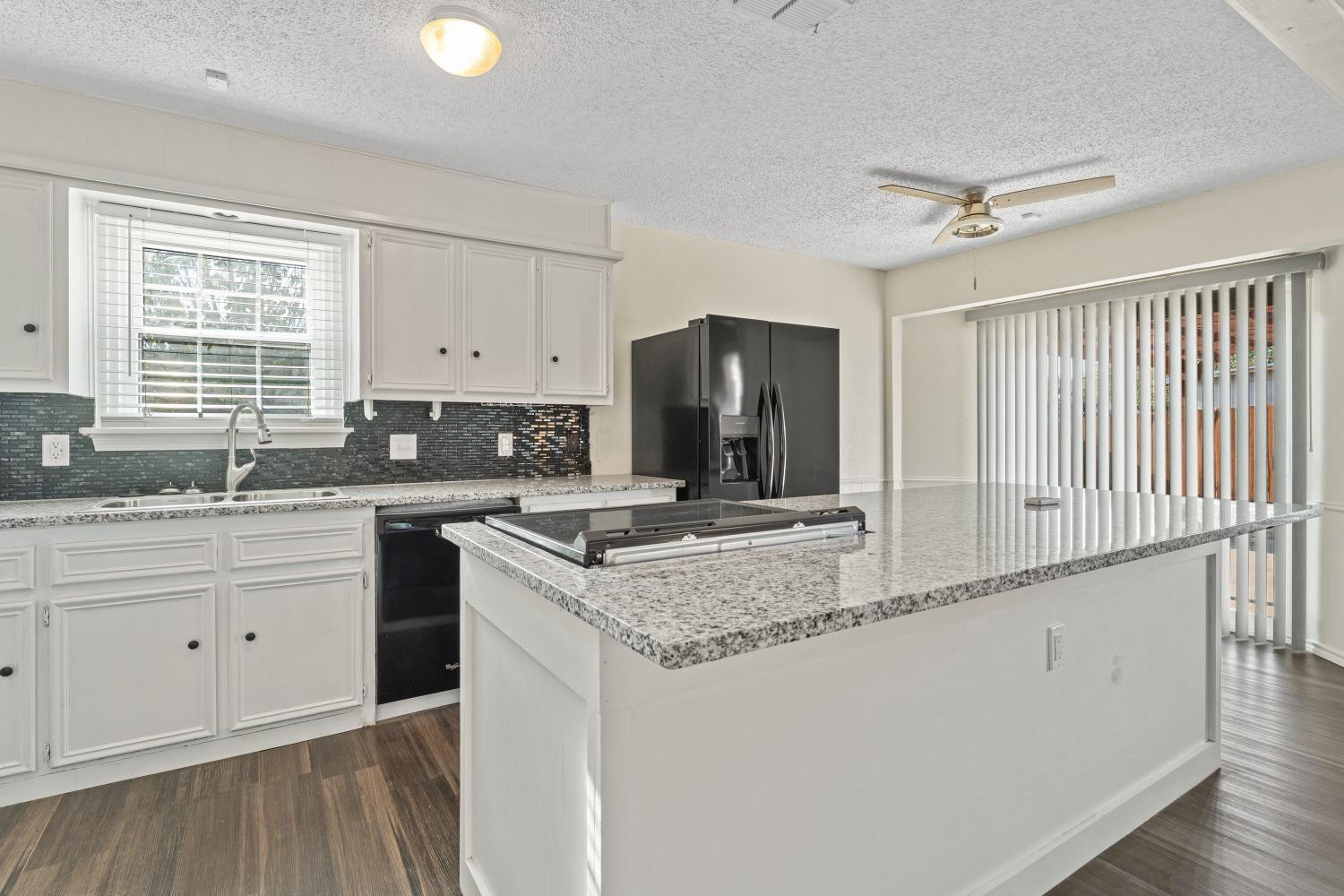 6154 38th Street Lubbock, TX 79407 - Photo 9 of 23 a kitchen with stainless steel appliances granite countertop a sink and a stove
