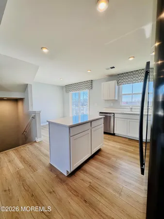 a view of a house with a wooden fence