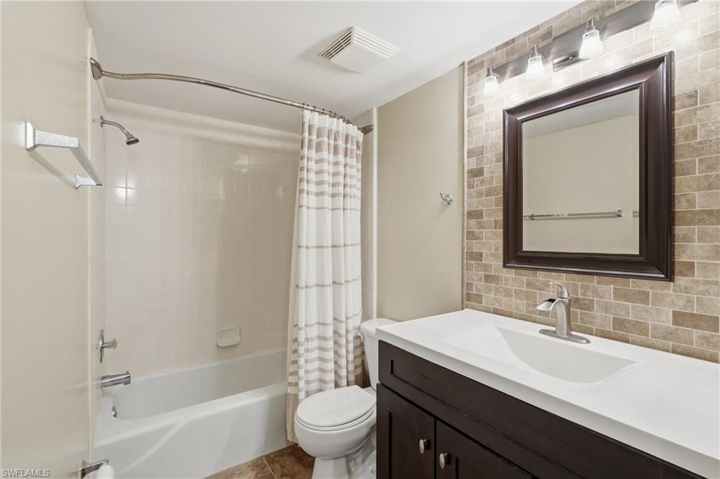5435 Rattlesnake Hammock Road, Unit E107 Naples, FL 34113 - Photo 11 of 14 GUEST BATH WITH MODERN UPDATED VANITY, ACCENT WALL, AND CUSTOM LIGHTING..