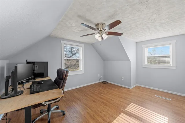 a view of a workspace with furniture and a window