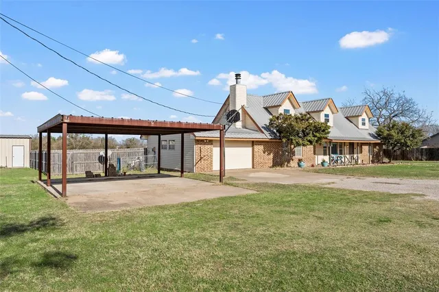 a view of a house with a yard and garage