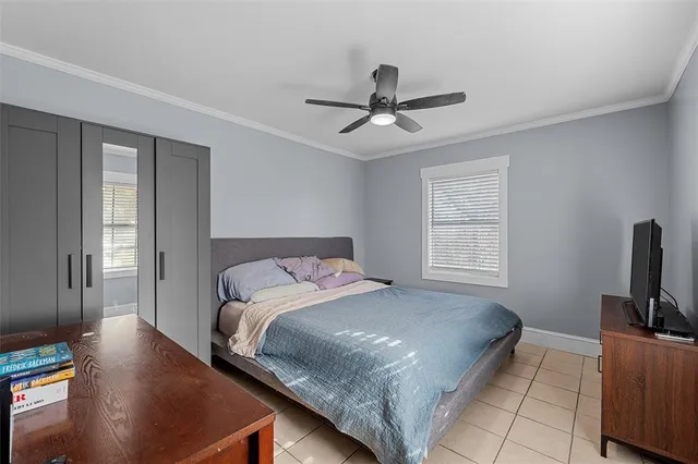 a bedroom with a bed table and a flat screen tv