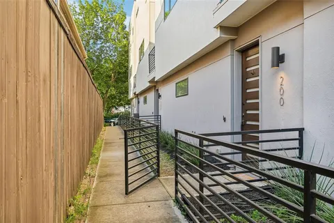 a view of balcony with wooden floor and fence and a window