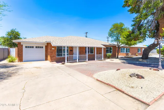 a front view of a building with a garden