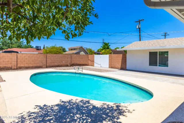 a swimming pool with outdoor seating and yard