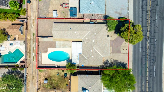 an aerial view of a house with a swimming pool