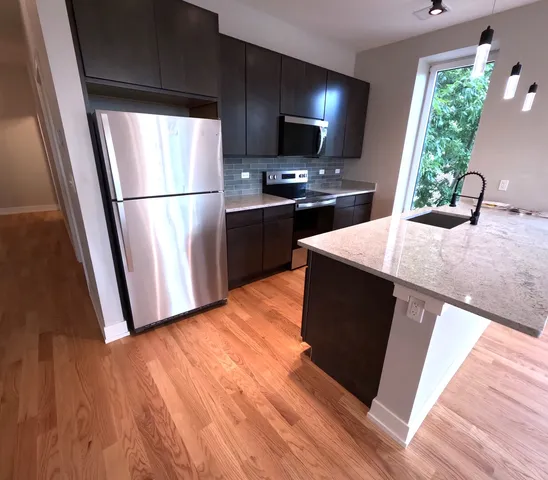 a kitchen with wooden cabinets and sink