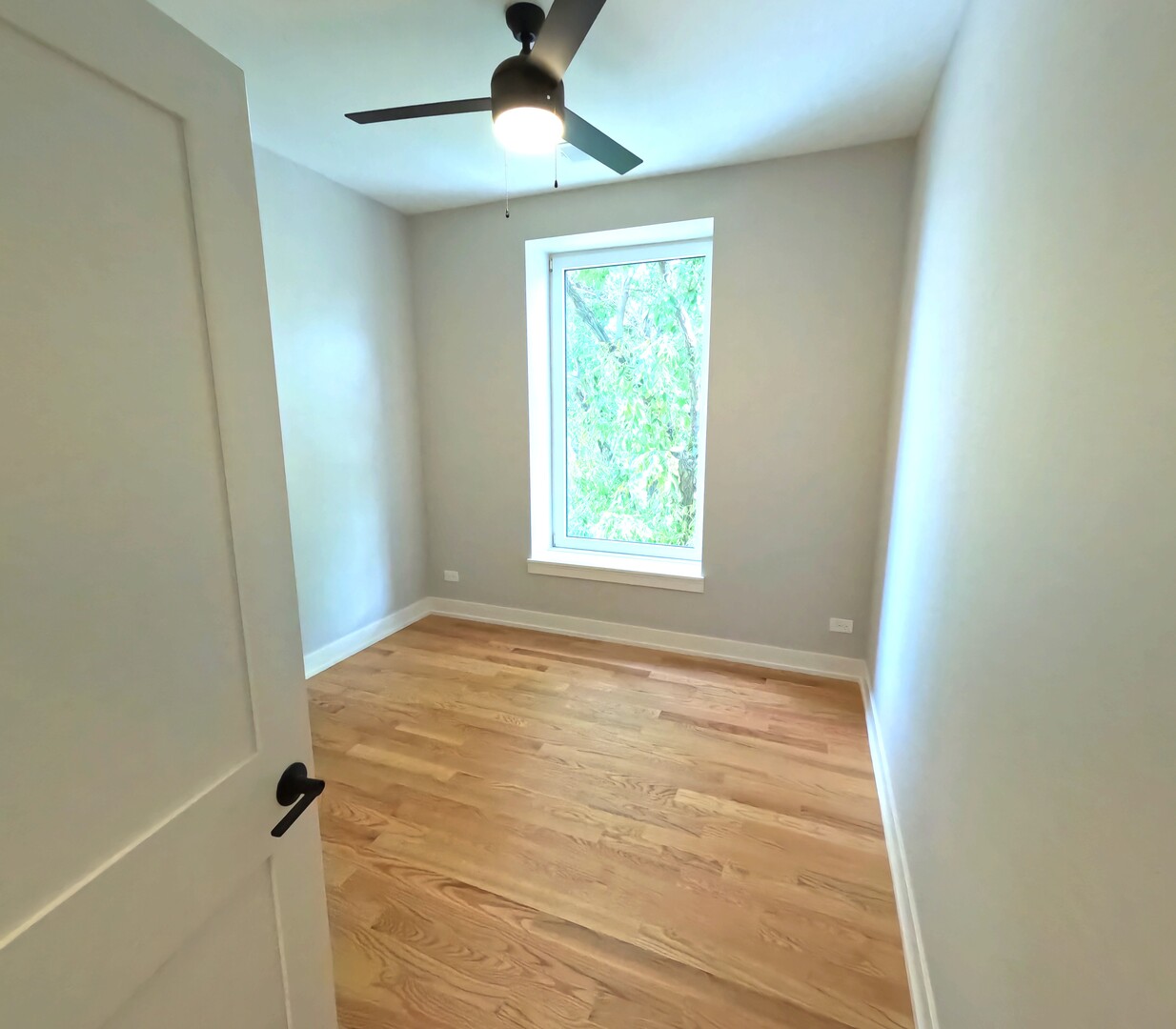 2100 West 18th Place, Unit 401 Chicago, IL 60608 - Photo 7 of 13 an empty room with a window and a ceiling fan