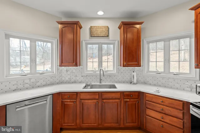 a kitchen with granite countertop white cabinets and white appliances