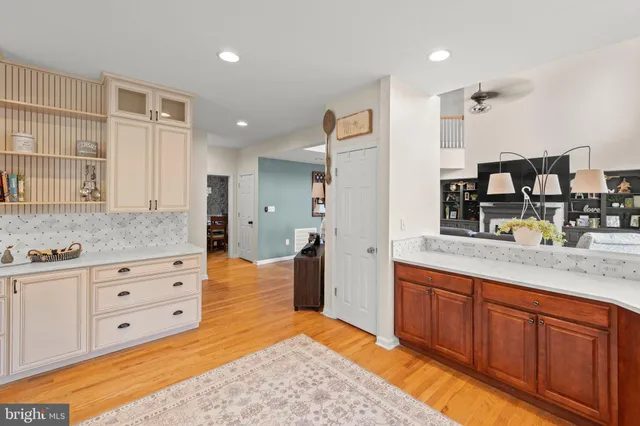 a dining room with furniture a chandelier and wooden floor
