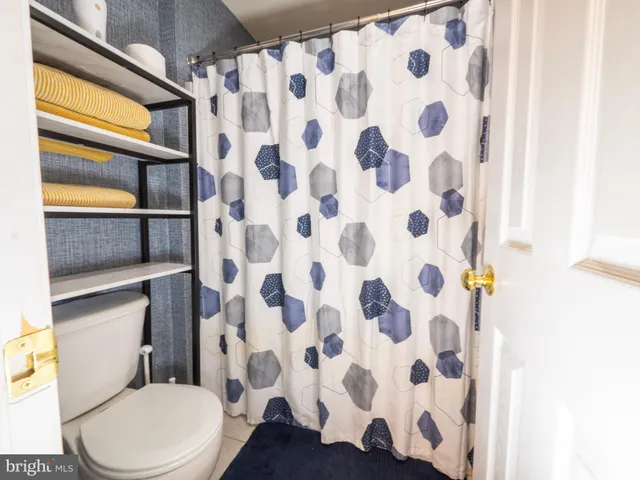a spacious bedroom with a bed and a chandelier