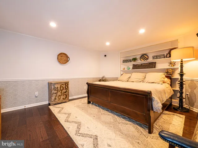 a view of a swimming pool with an ocean and trees in the background