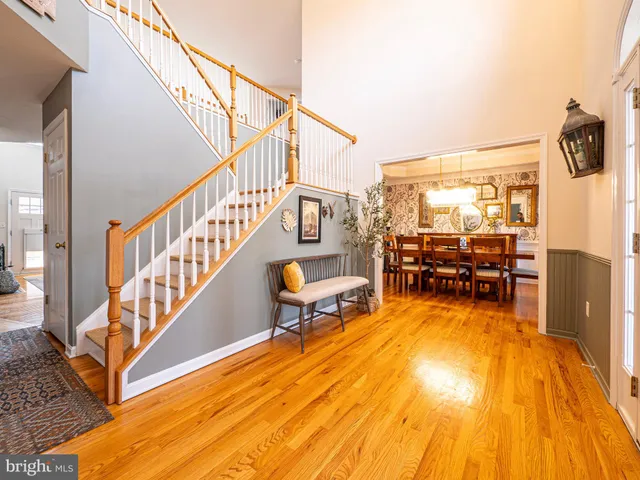 a large kitchen with stainless steel appliances granite countertop a refrigerator a stove a sink dishwasher a oven with wooden cabinets and floor