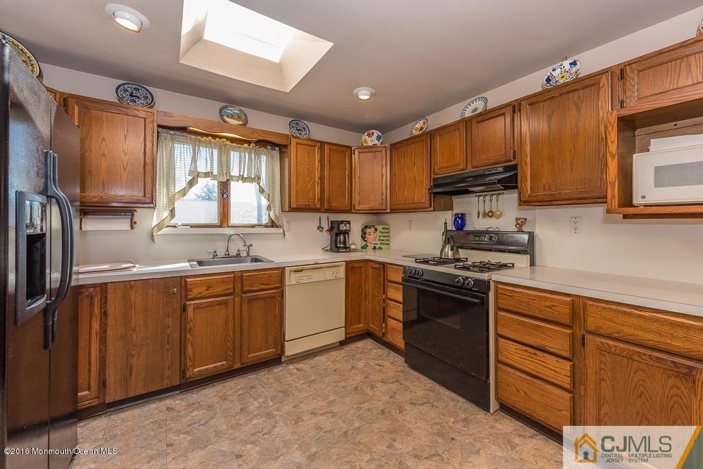 130 Bethany Road Hazlet, NJ 07730 - Photo 11 of 24 a kitchen with granite countertop cabinets stainless steel appliances a sink and a window