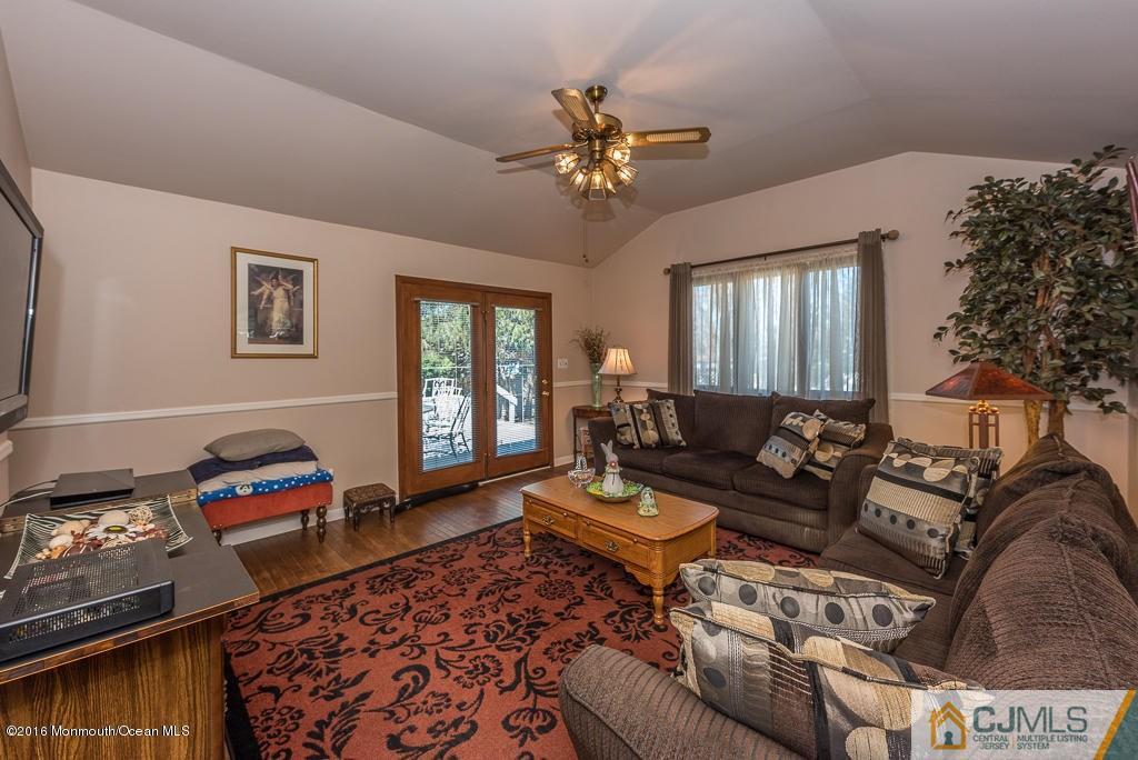 130 Bethany Road Hazlet, NJ 07730 - Photo 14 of 24 a living room with furniture and a chandelier
