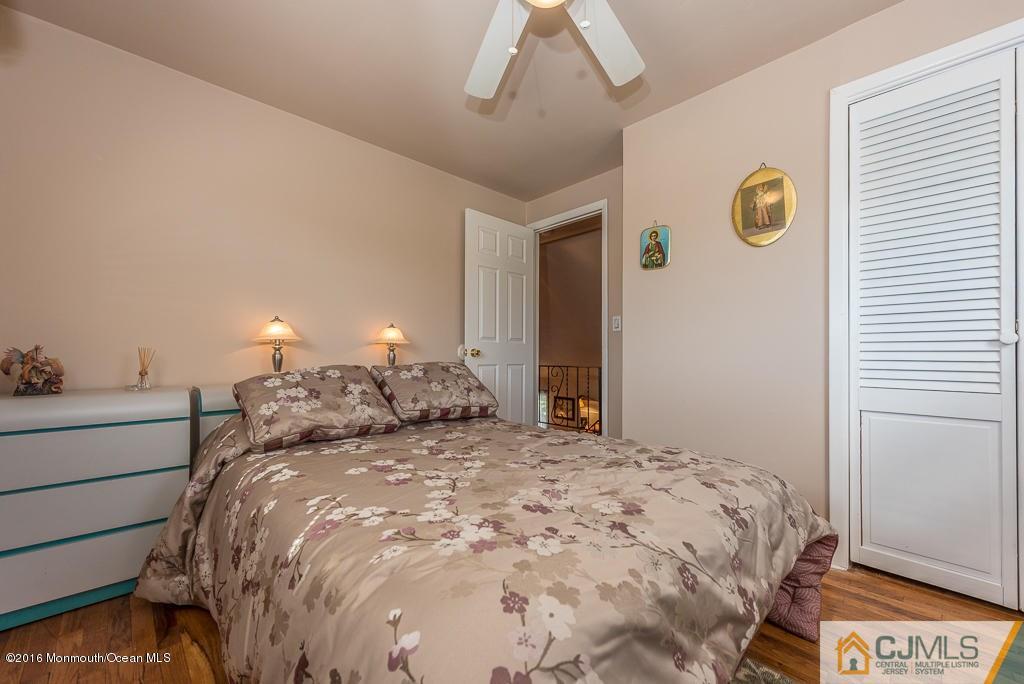 130 Bethany Road Hazlet, NJ 07730 - Photo 16 of 24 a bed sitting in a bedroom next to a window