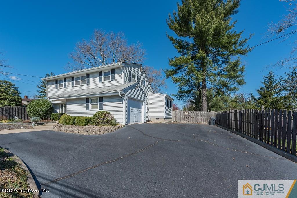 130 Bethany Road Hazlet, NJ 07730 - Photo 3 of 24 a front view of a house with a yard and garage