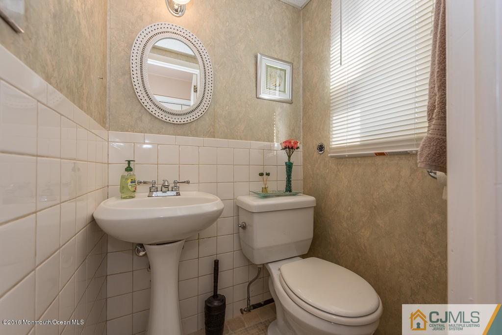 130 Bethany Road Hazlet, NJ 07730 - Photo 6 of 24 a bathroom with a toilet a sink and a mirror