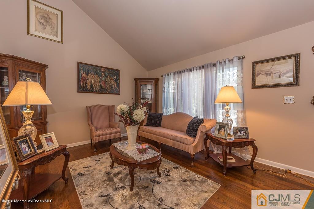 130 Bethany Road Hazlet, NJ 07730 - Photo 9 of 24 a living room with furniture and a lamp