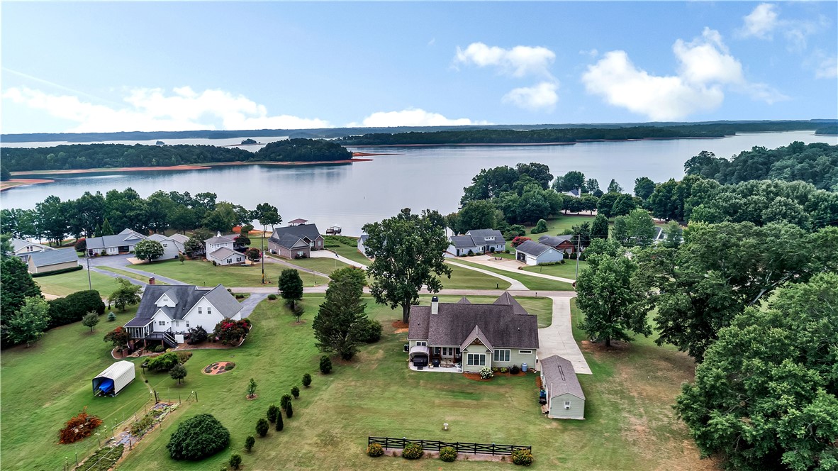 1204 Cherokee Road Townville, SC 29689 - Photo 43 of 44 An aerial panorama reveals a tranquil lakeside community with lush green lawns and a broad water vista.