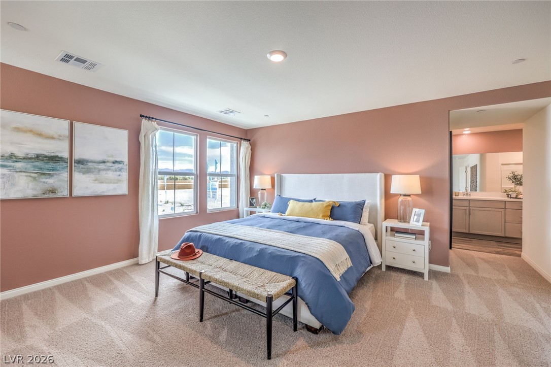 1013 Copper Robin Street Henderson, NV 89011 - Photo 18 of 43 Photo is representational only; actual home finishes may vary. Bedroom featuring light carpet and baseboards