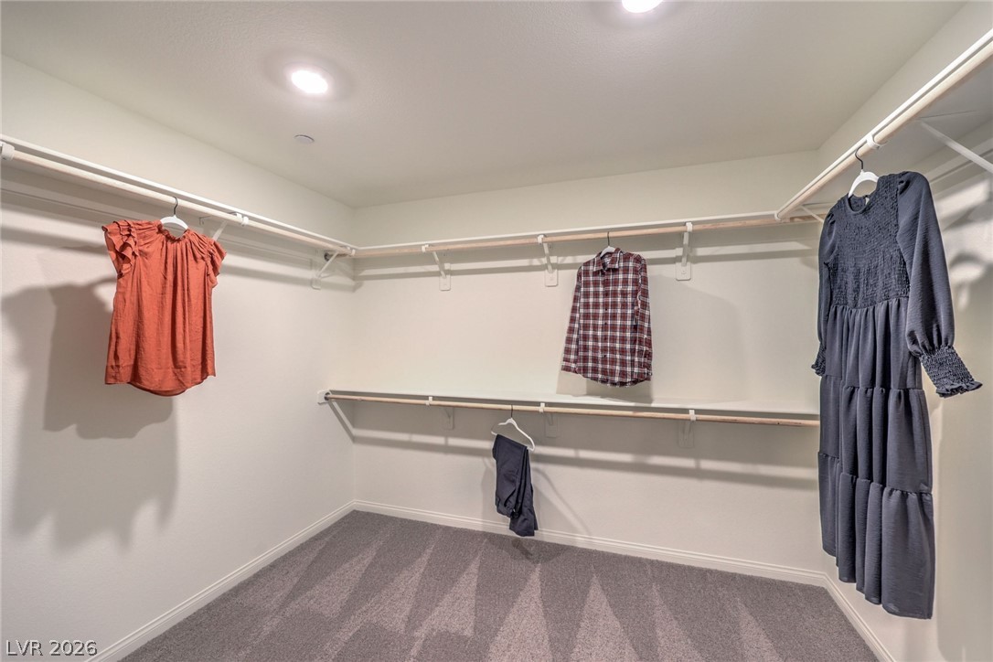 1013 Copper Robin Street Henderson, NV 89011 - Photo 25 of 43 Photo is representational only; actual home finishes may vary. Spacious closet featuring dark colored carpet