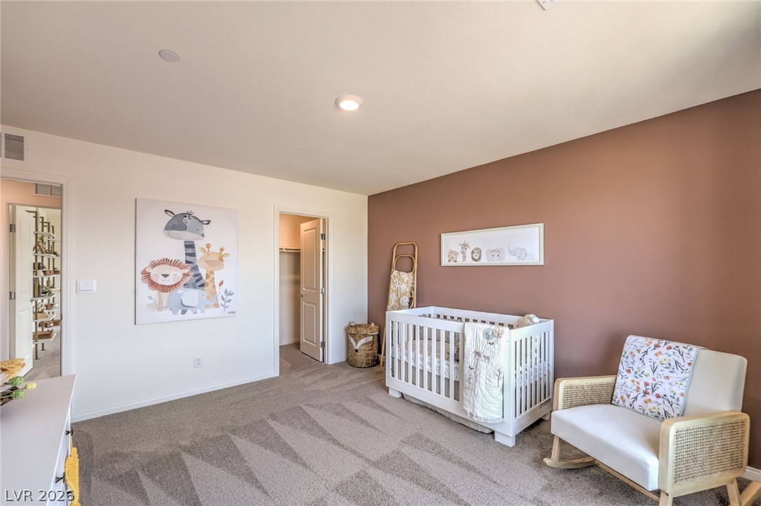 1013 Copper Robin Street Henderson, NV 89011 - Photo 31 of 43 Bedroom featuring carpet, baseboards, and a spacious closet. Photo is representational only; actual home finishes may vary.