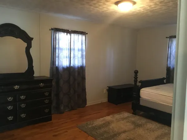a bedroom with a bed and a mirror